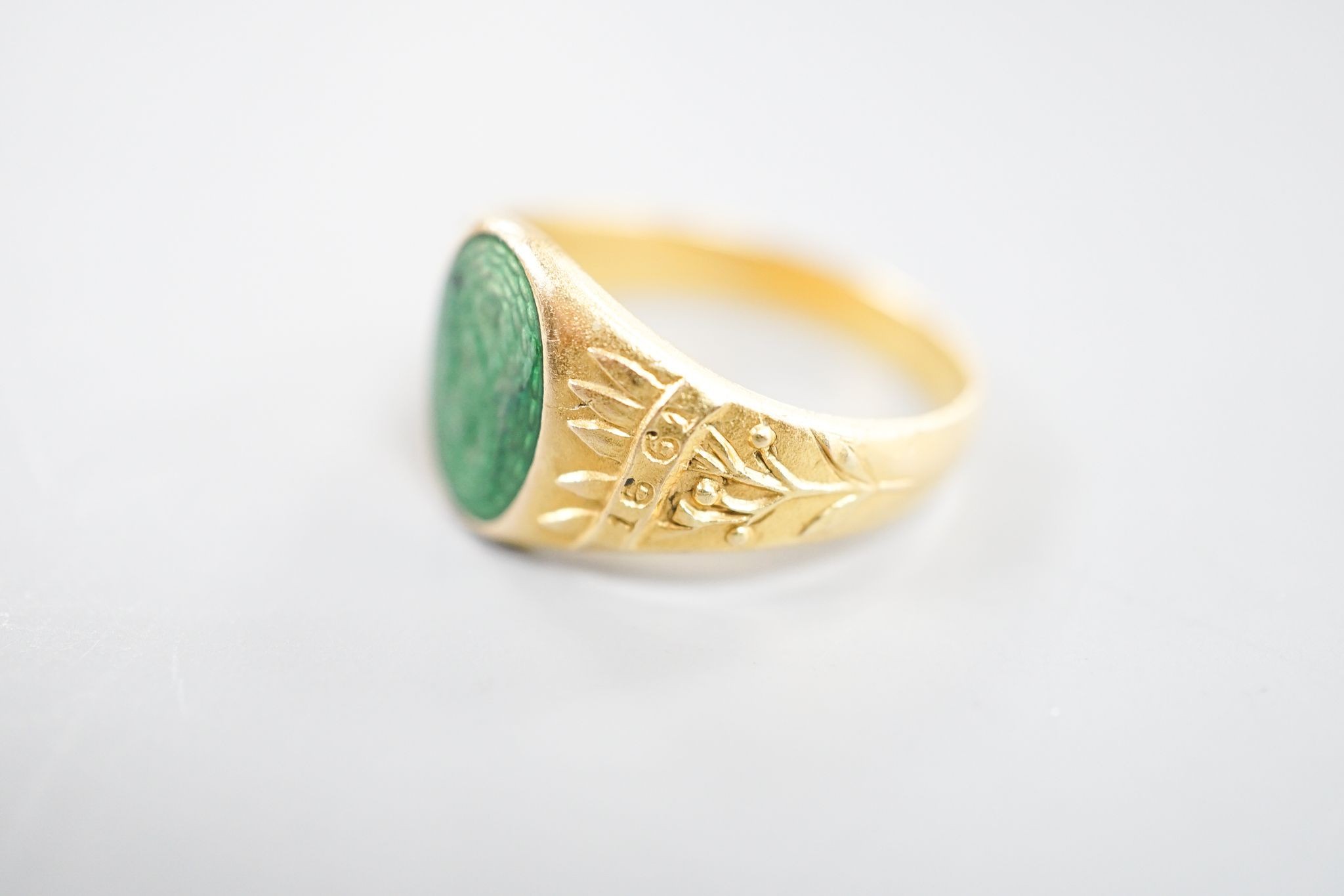 An early 20th century Austro-Hungarian (Vienna) 580/1000 yellow metal and green enamel signet ring, depicting the bust of a gentleman to sinister, size Q/R, gross 6.7 grams.